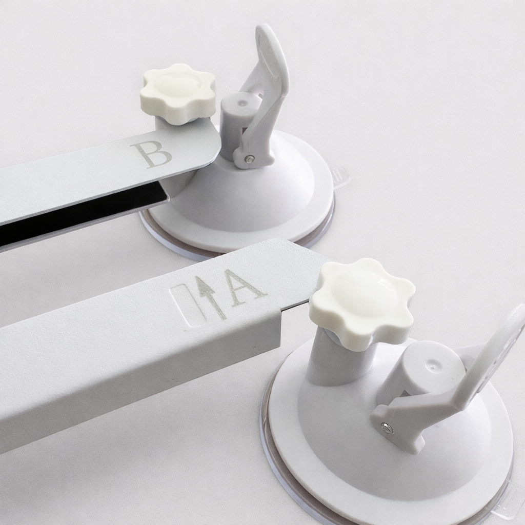 Close-up view of Starlink Mini suction cup mount ends marked A and B, showing knob and lever detail against neutral grey background
