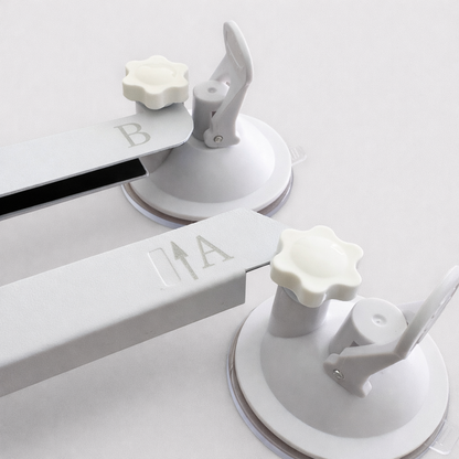 Close-up view of Starlink Mini suction cup mount ends marked A and B, showing knob and lever detail against neutral grey background
